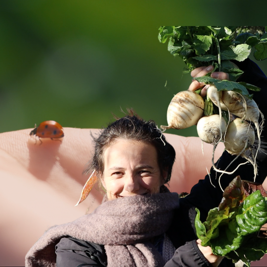 Sophie holding up veggies