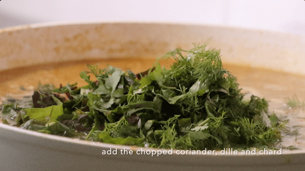 Add the fresh herbs and chard to the curry