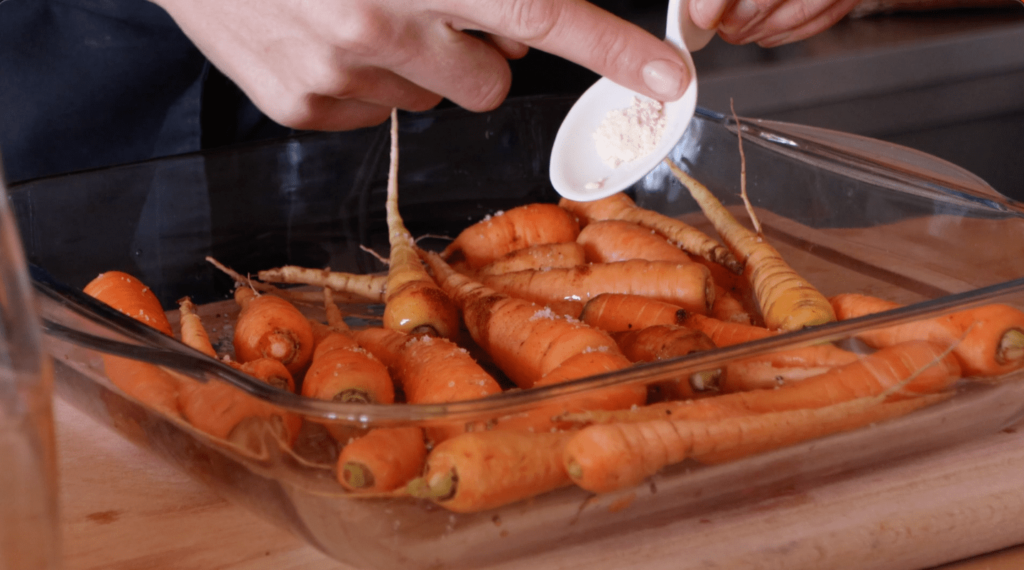 The Farming Chefs, adding dried garlic, to carrots