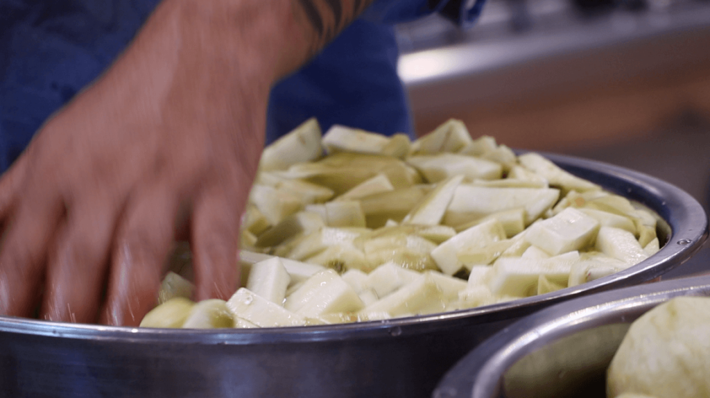 SLICE ALL THE AUBERGINES AND KEEP IN WATER