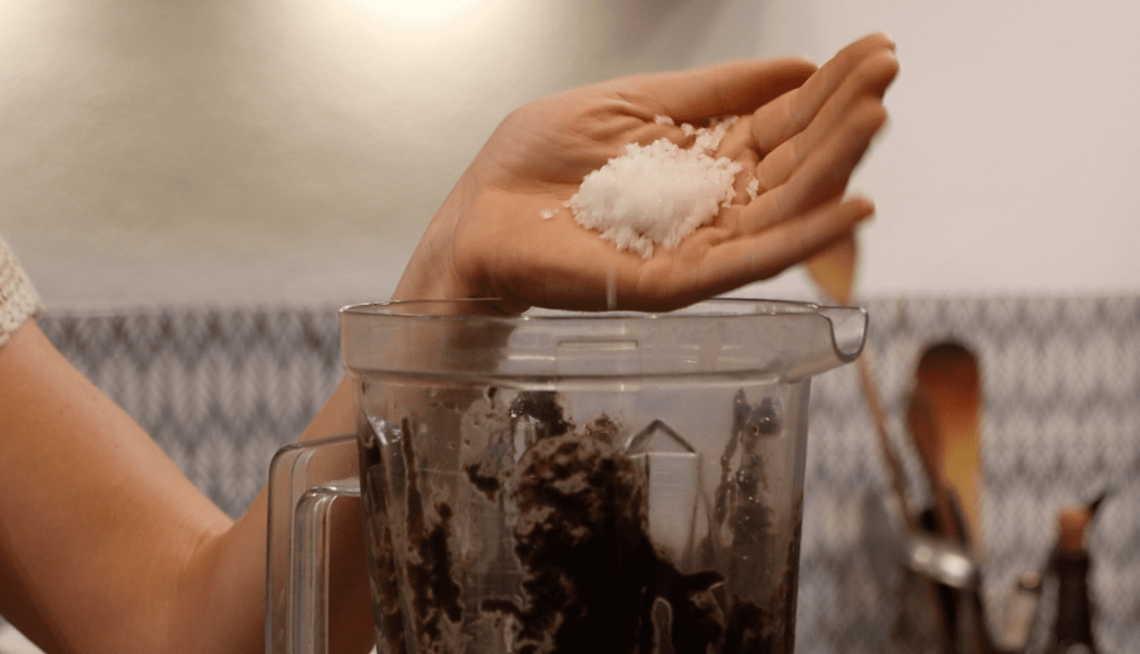 salt falling from a hand into a blender