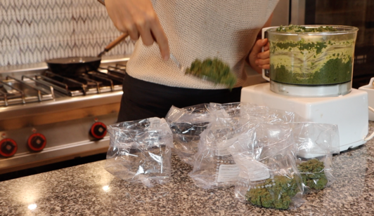 woman putting green puree in indiviual little bags