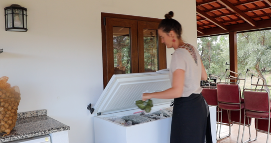 woman storing something in freezer