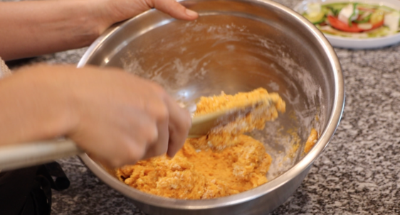 big metal bowl with orange dough