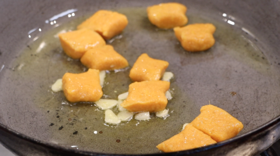 gnocchi frying in olive oil with fresh garlic