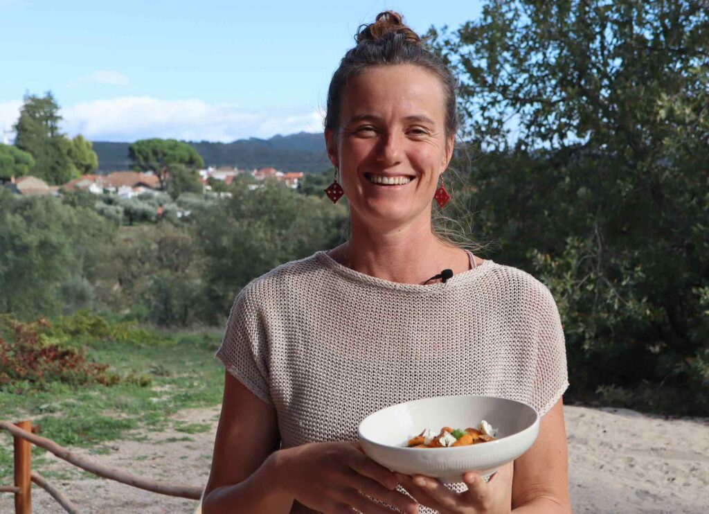 The farming chef's, sophie in the garden with a plate of sweet potato gnocchi