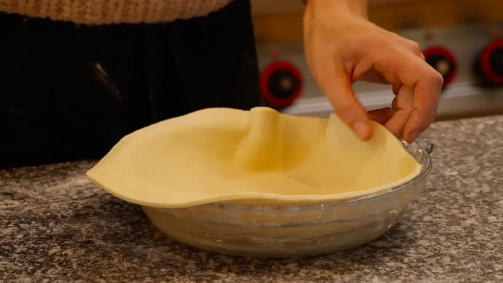 dough sheet in glass pie dish