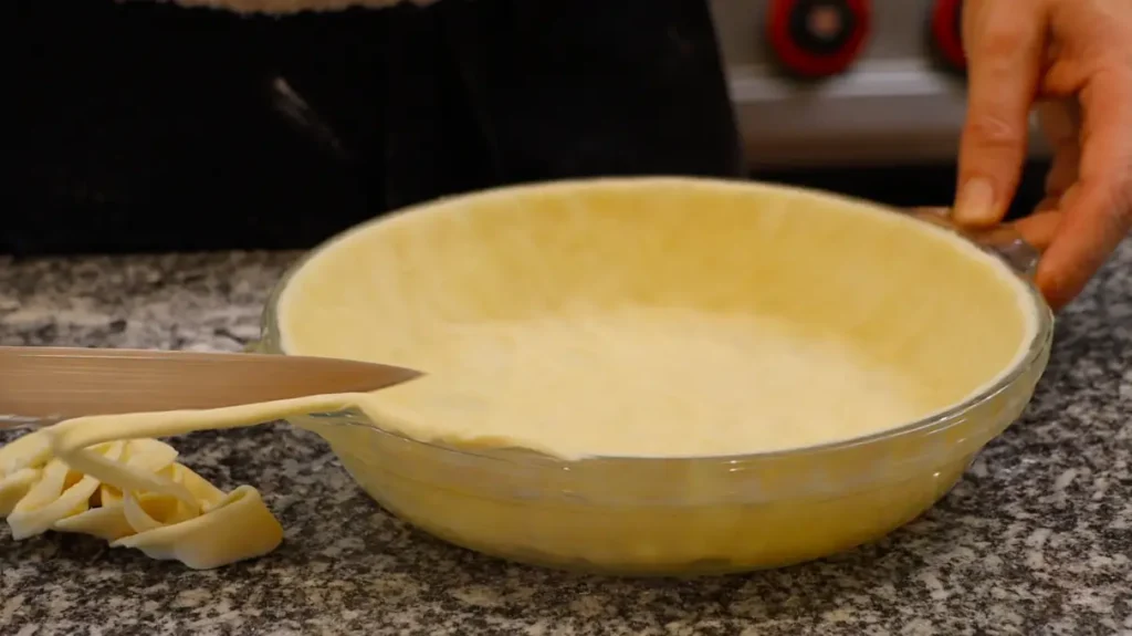 knife slicing off dough edges