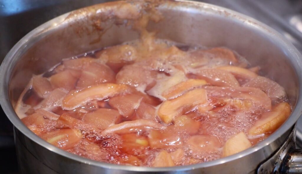 pot with liquid, different fruits