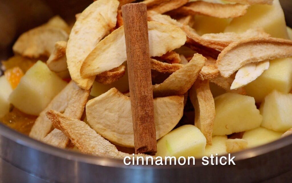 cinnamon stick laying on dried fruit slices