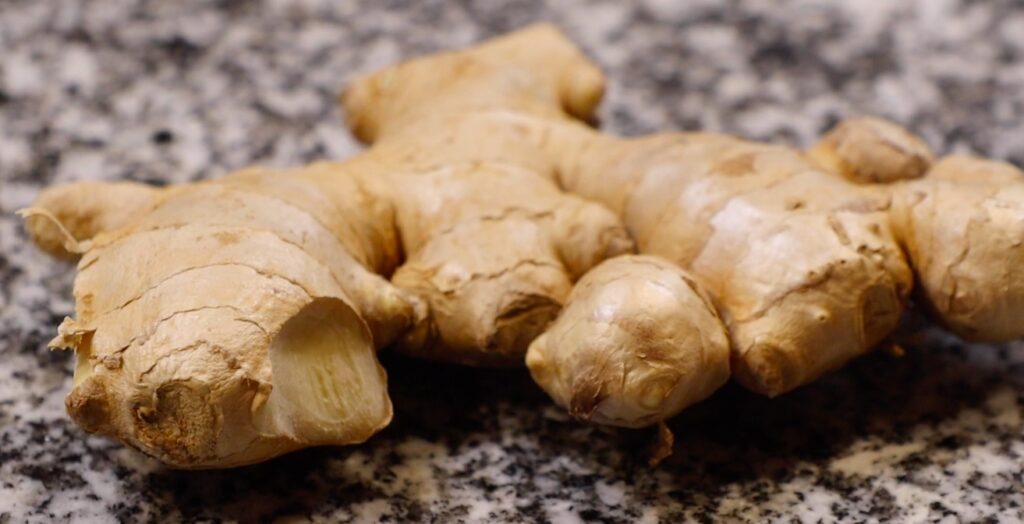 ginger root on black and white stone surface