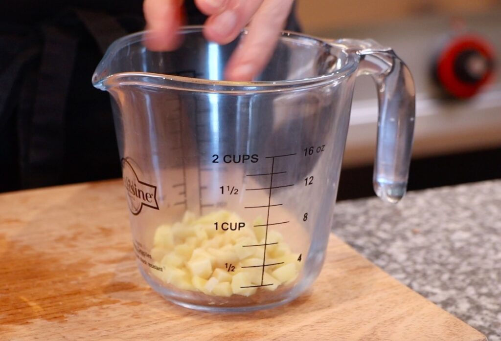 chopped ginger in glass measuring cup