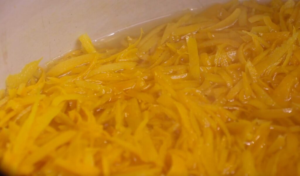 thin slivers of orange peel in water