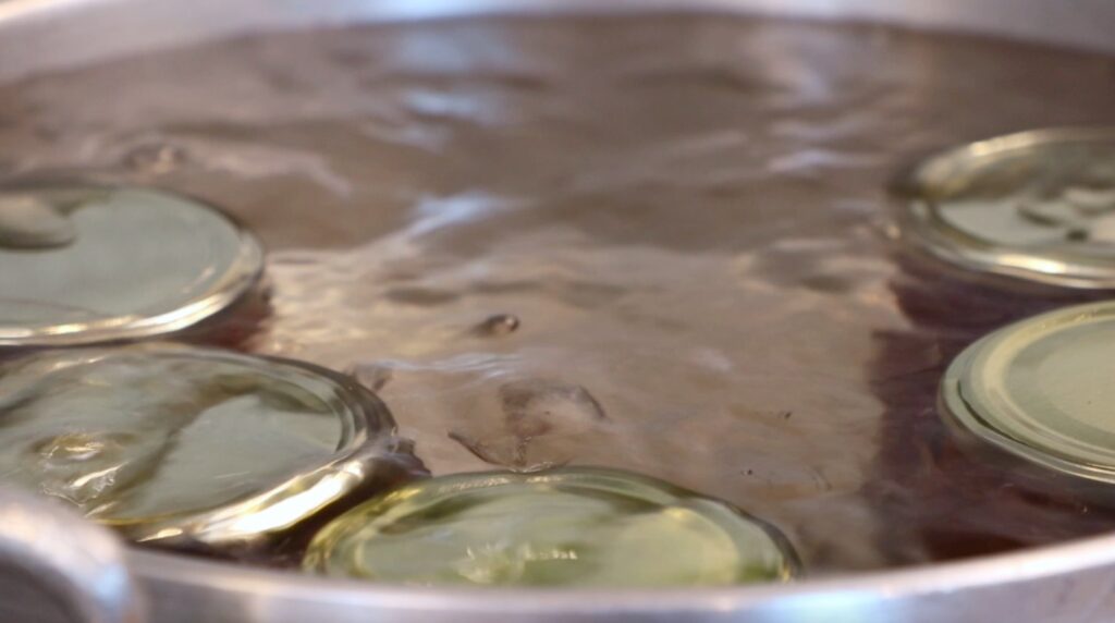 jars with lid in pot, submersed in water