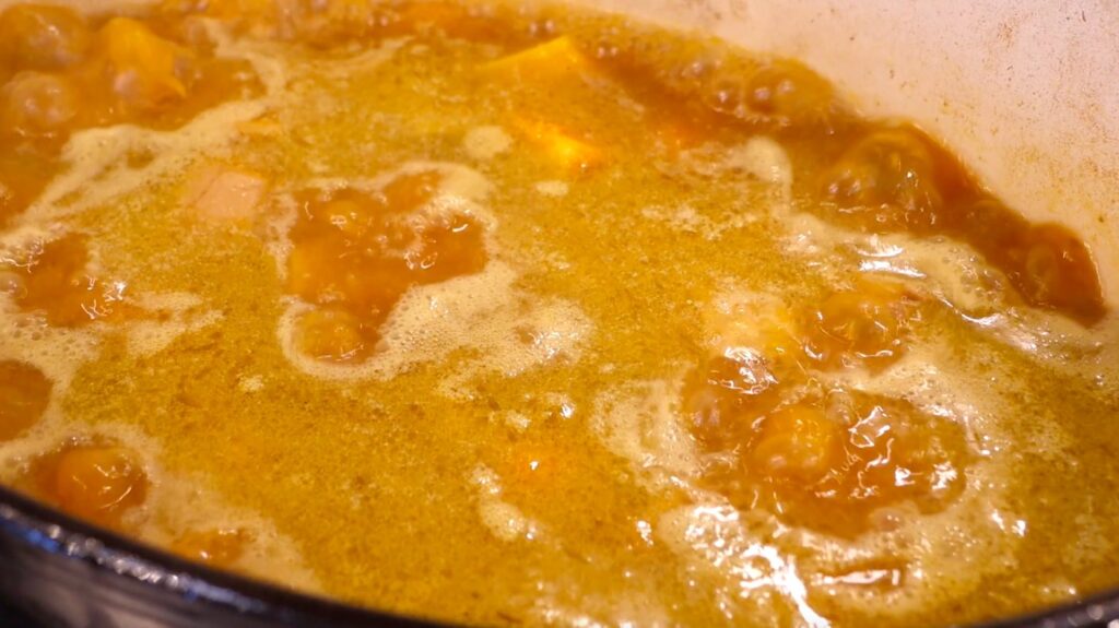 close-up of orange liquid with pieces bubbling