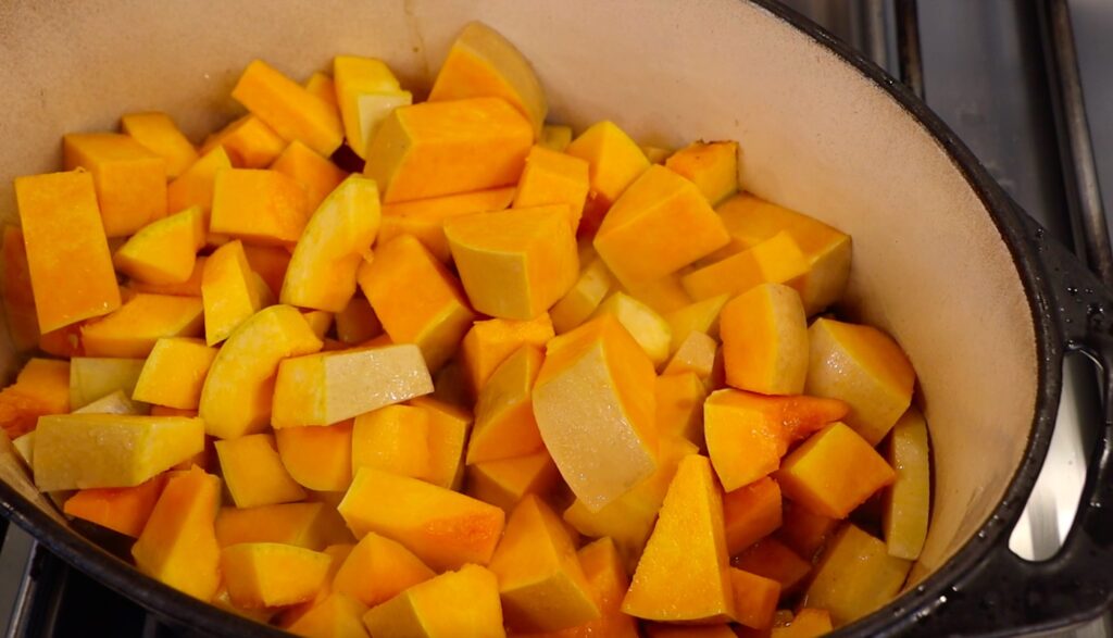 big oval pot filled with bright orange pumpkin cubes