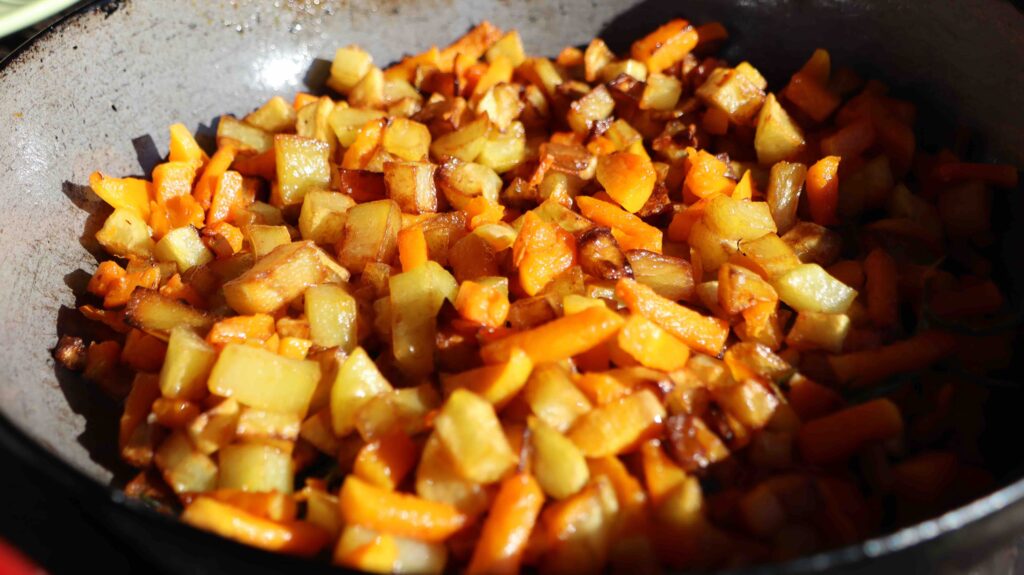 pan with fried potatoes and pumpkin, bright orange, golden brown