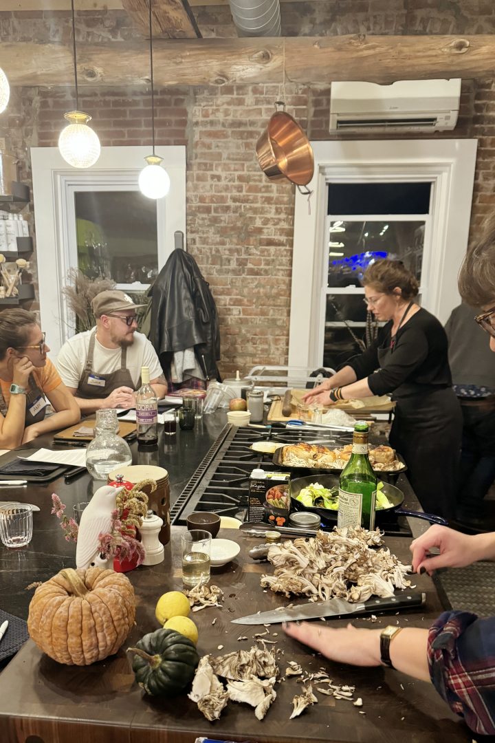 Cooking class participants preparing a shared dinner