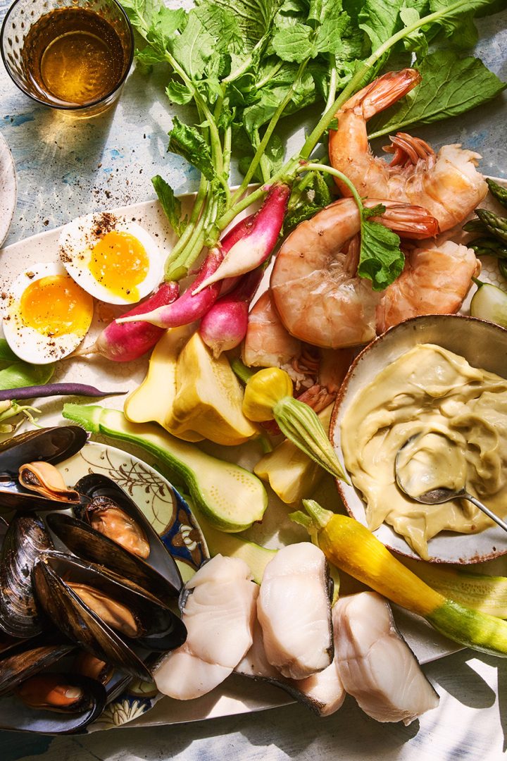 A platter of shrimp, mussels, fish, garden vegetables and aioli